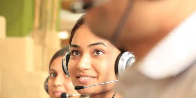 woman in black headphones holding black and silver headphones